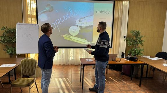 Dwaj mężczyźni patrzą na tablicę.