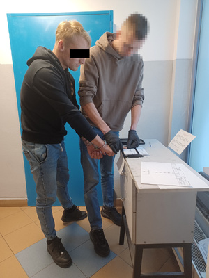 Policjant z zatrzymanym.