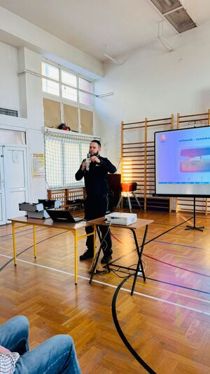 Policjant stoi przed nauczycielami.